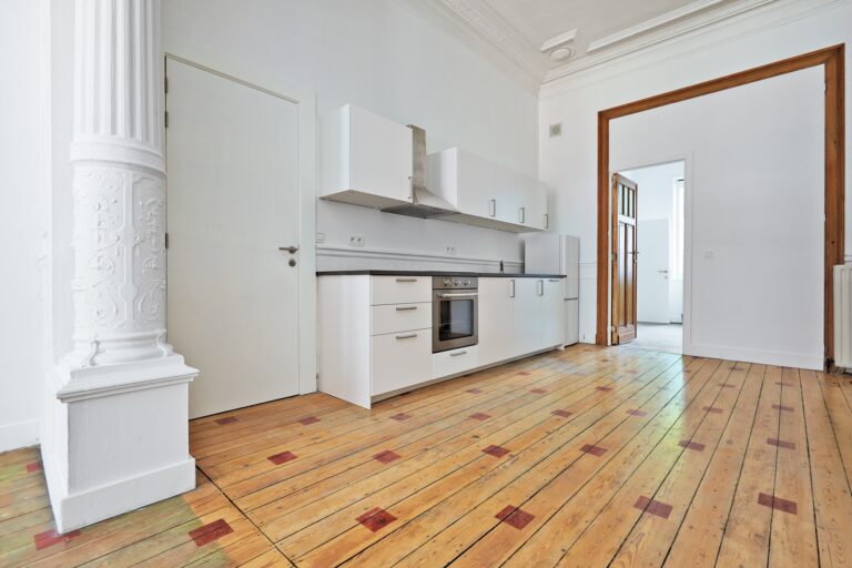 Empty apartment with modern kitchen and designed hardwood